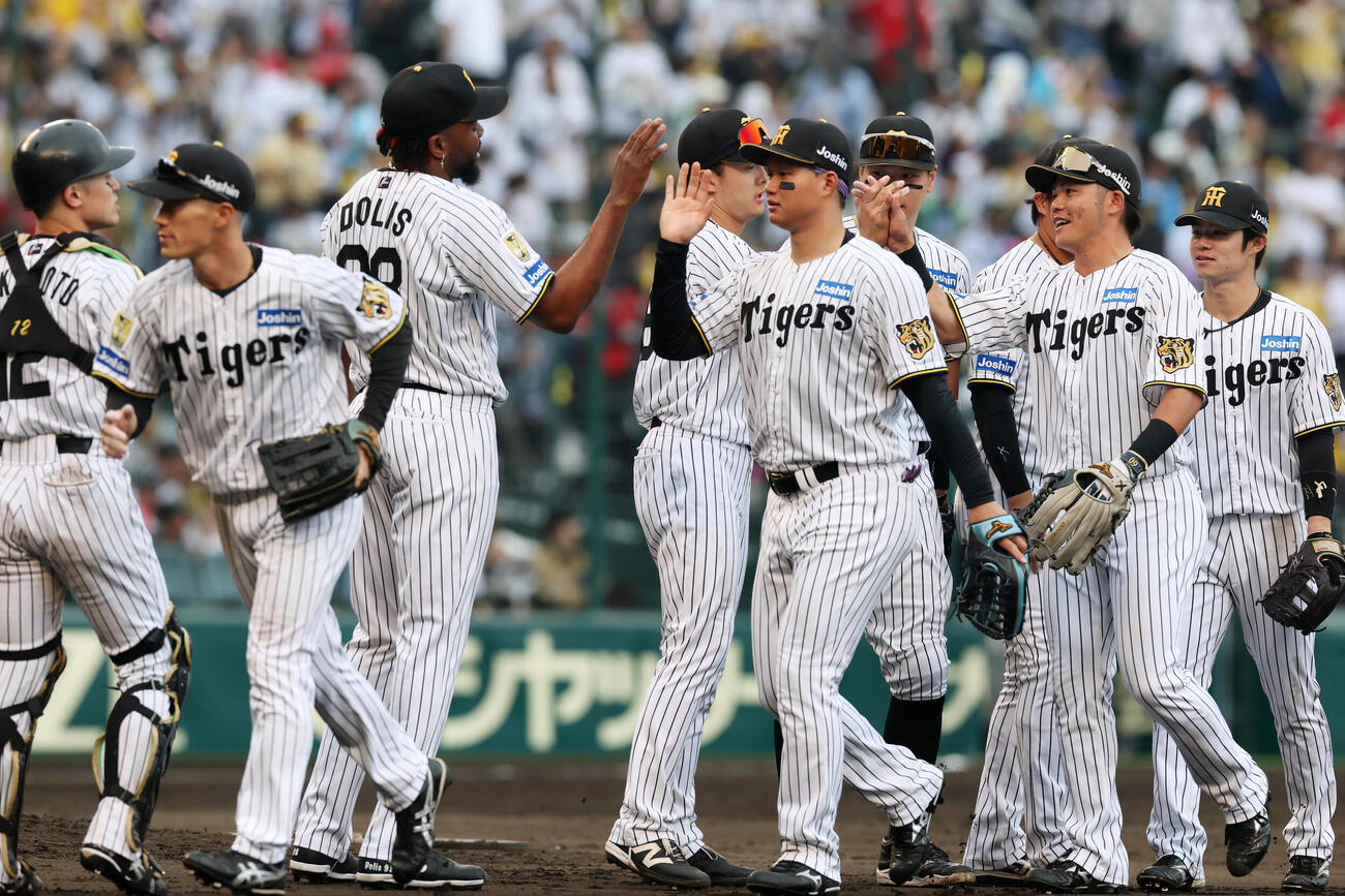 阪神対広島　広島に勝利しマウンドでナインとタッチ阪神ラファエル・ドリス（撮影・加藤哉）