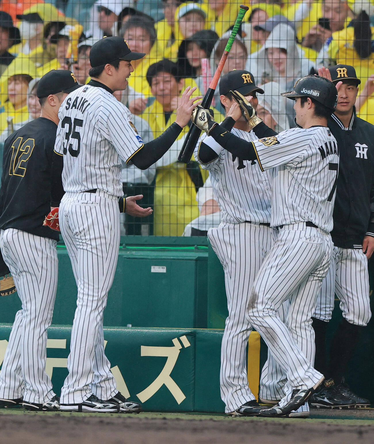 阪神対巨人　4回裏阪神1死一塁、才木浩人（左から2人目）は佐藤輝明の適時三塁打で生還した一走中野拓夢（右）を出迎える（撮影・上山淳一）