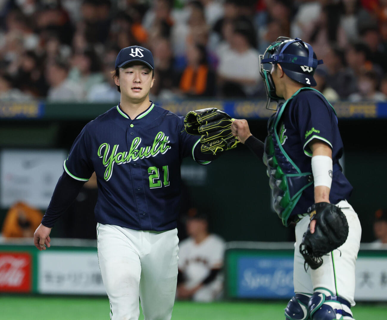 巨人対ヤクルト　8回裏2死一、二塁のピンチをしのぎタッチを交わす古賀優大（右）と吉村貢司郎（撮影・増田悦実）