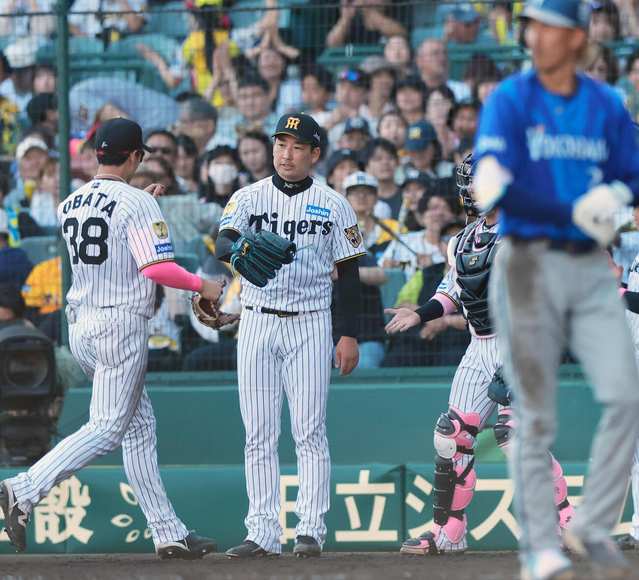 阪神対DeNA 8回表を終え、好守を見せた小幡竜平（左）を出迎える岩崎優（撮影・上山淳一）