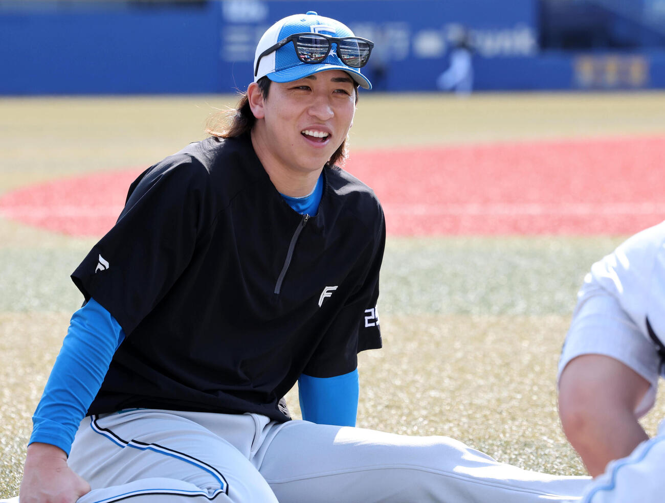 ロッテ対日本ハム　リラックスした笑顔でストレッチする日本ハム細野晴希（撮影・浅見桂子）