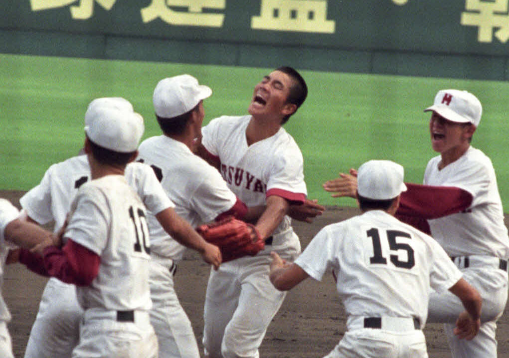 96年8月、熊本工戦の延長10回裏1死満塁、本多の右飛を好返球し、サヨナラを防いだ松山商の右翼手・矢野勝嗣（中央）はナインに迎えられる