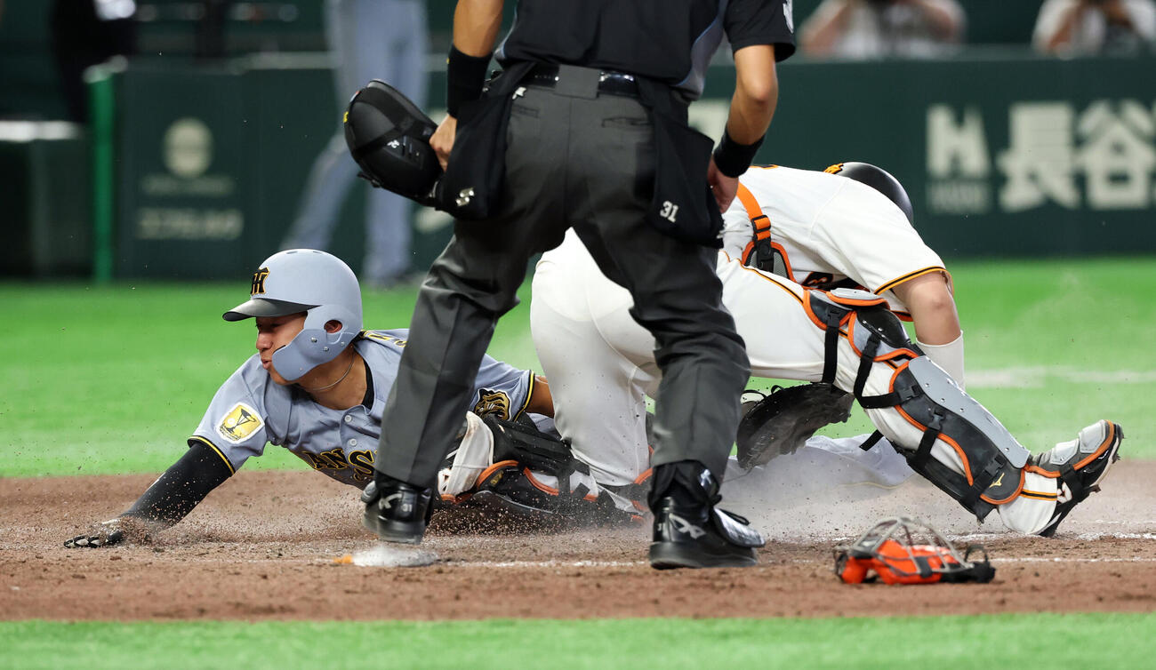 巨人対阪神　7回表阪神2死一、二塁、佐藤輝明の適時打でヘッドスライティングで生還する立石正広。捕手大城卓三（撮影・浅見桂子）