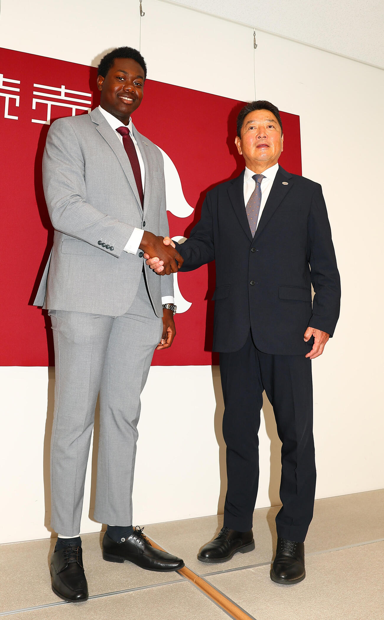 支配下登録され吉村禎章編成本部長（右）と握手する巨人フリアン・ティマ（撮影・野上伸悟）＝2026年5月25日