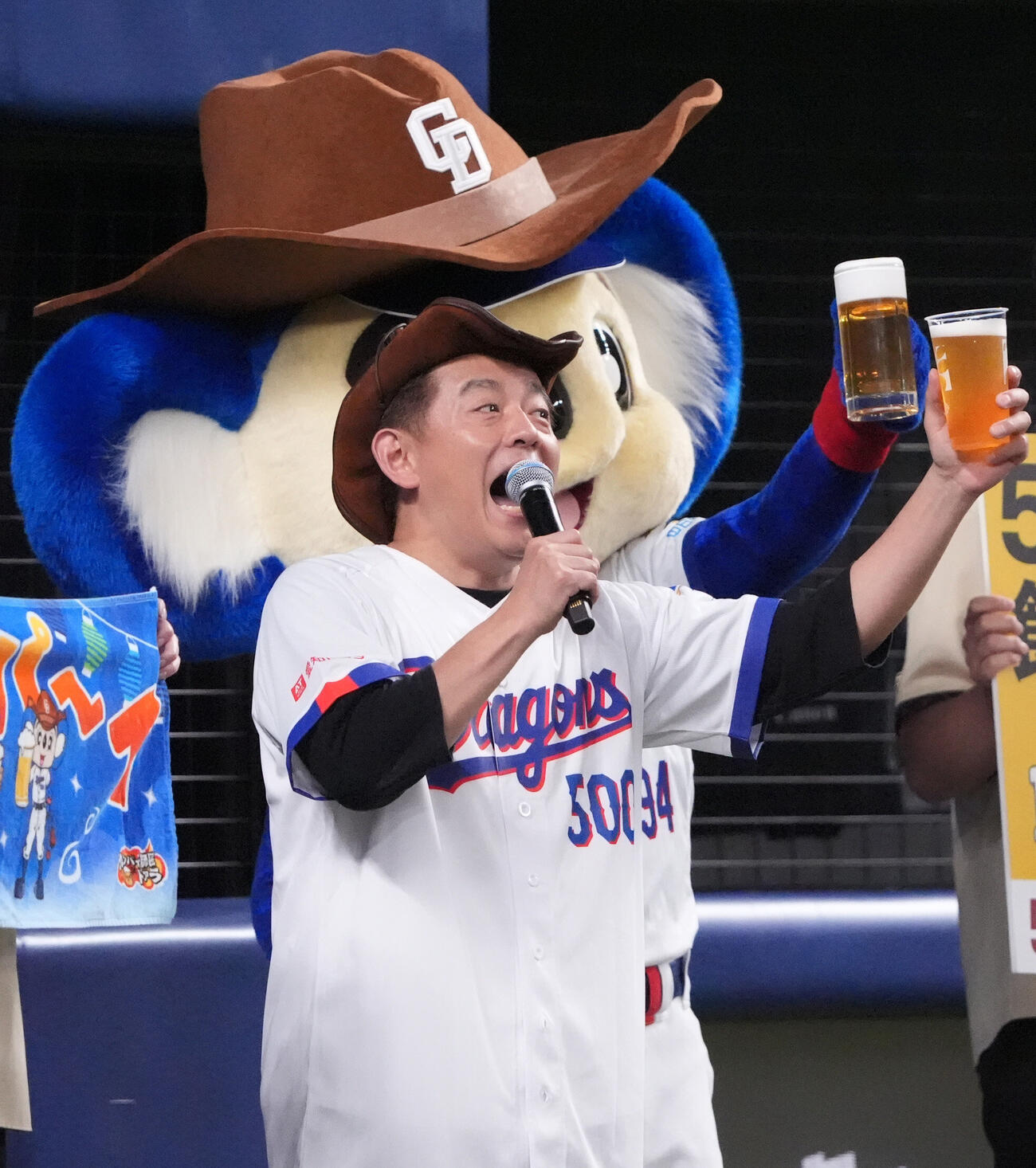 プロ野球交流戦中日対楽天　2回終了、スタンドの観客と乾杯するカンパイ師匠の井戸田潤（撮影・森本幸一）