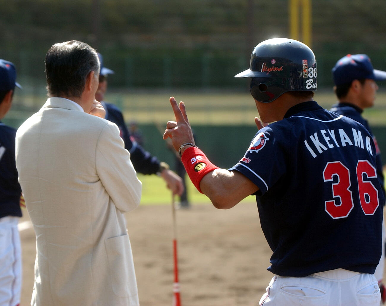 巨人長嶋茂雄終身名誉監督（左）の後ろでVサインを作りおどけるヤクルト池山隆寛（02年2月6日撮影）