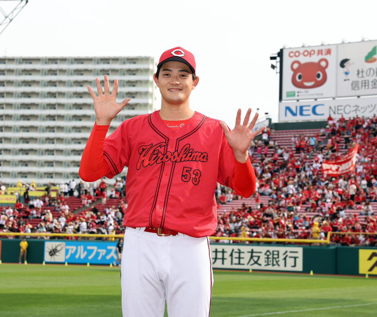 楽天対広島　5勝目の広島岡本駿は広島の応援団を背に笑顔で両手で「5」のポーズ（撮影・浅見桂子）