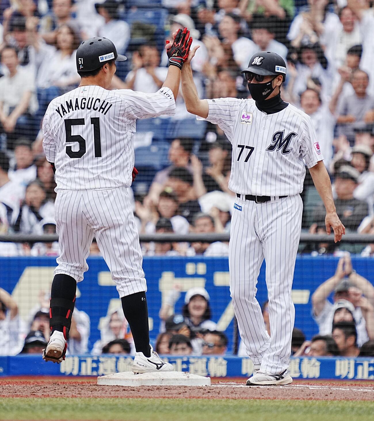 ロッテ対DeNA 5回裏ロッテ2死満塁、山口航輝は中前に勝ち越し2点適時打を放ち西岡剛一塁コーチ（右）とハイタッチ（撮影・小沢裕）　＝2026年6月14日