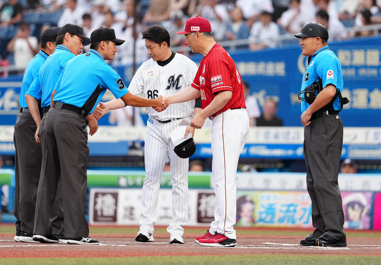ロッテ対楽天　メンバー表の最終確認に臨む楽天吉井理人監督（手前）とロッテのサブロー監督（中央）（撮影・鈴木みどり）