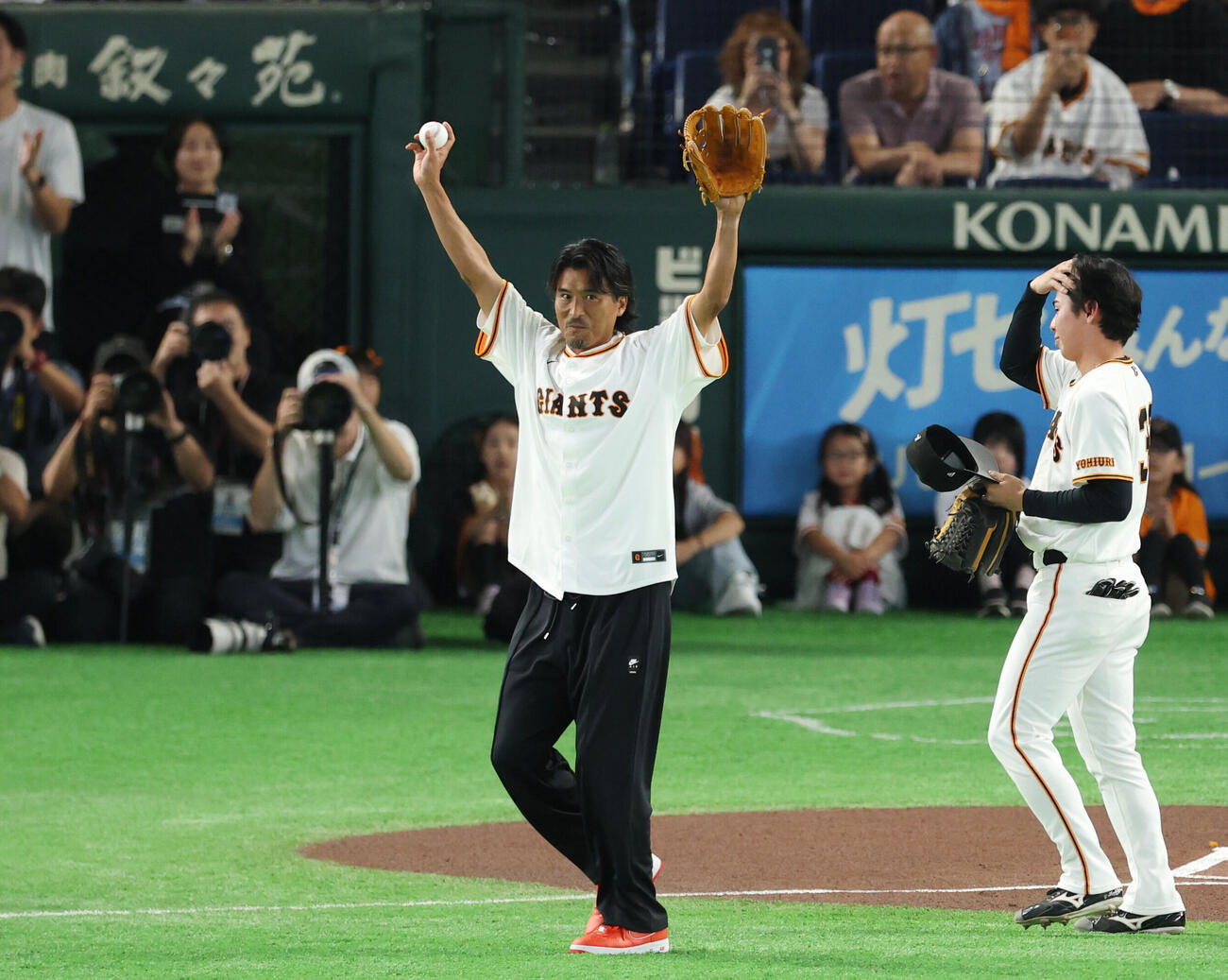 巨人対中日　ファーストピッチを終え手を振りながら引き揚げる中沢佑二氏（撮影・増田悦実）