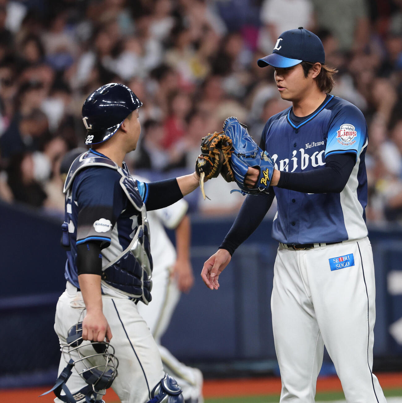 オリックス対西武　最後を締めた西武甲斐野央（右）は古賀悠斗捕手とタッチをかわす（撮影・西尾就之）