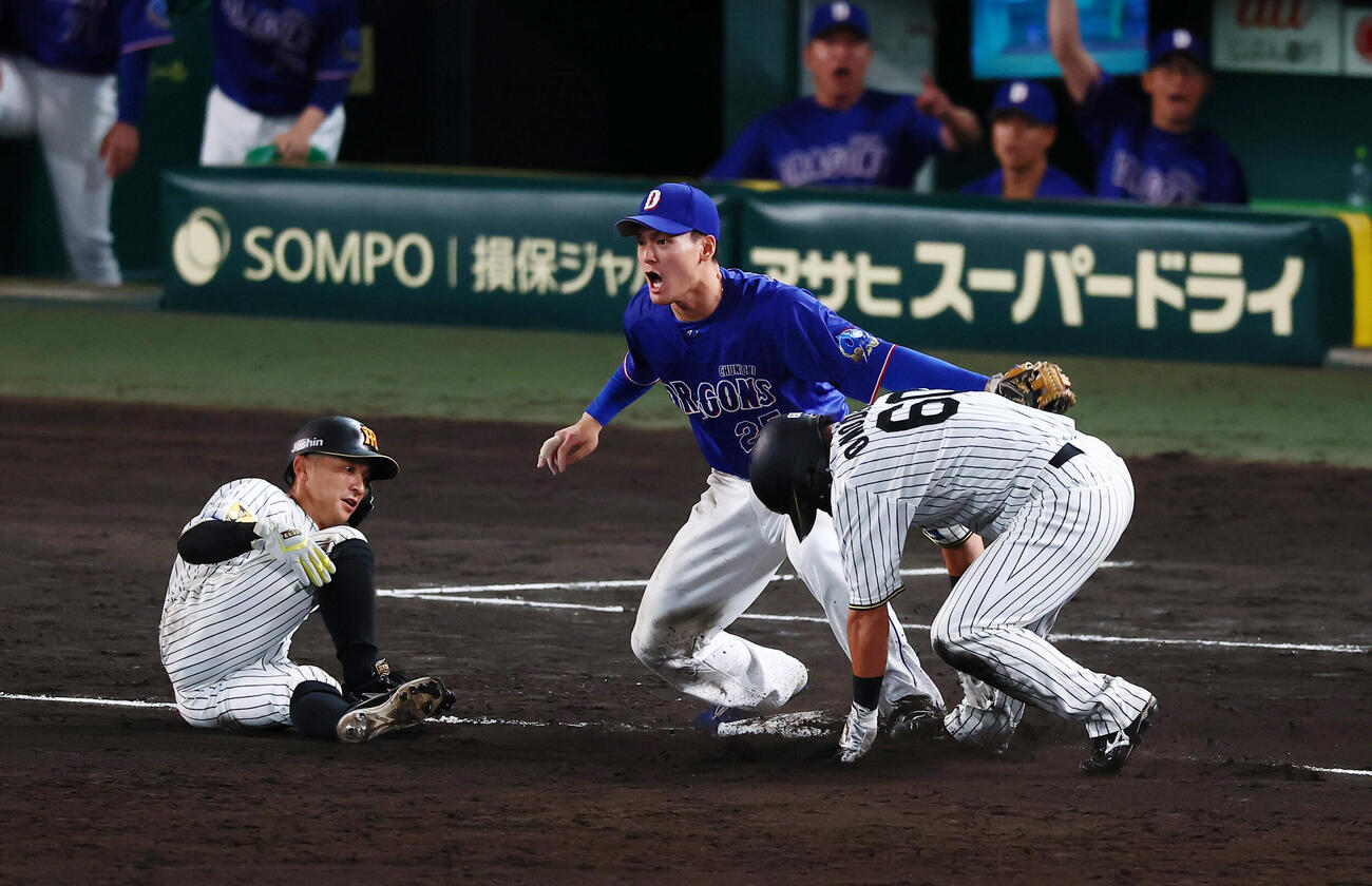 阪神対中日　7回裏阪神1死一、三塁、高寺望夢の一ゴロで三本間で挟殺された三走熊谷敬宥(左）に加え一走代走小野寺暖も三塁へ駆け込み石川昂弥(中央）にタッチされ併殺となる（撮影・加藤哉）