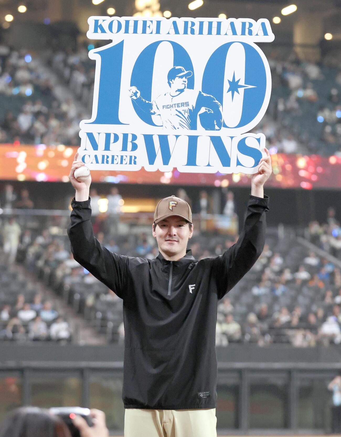 日本ハム対オリックス　NPB通算100勝を達成し記念ボードを掲げる有原航平（撮影・黒川智章）