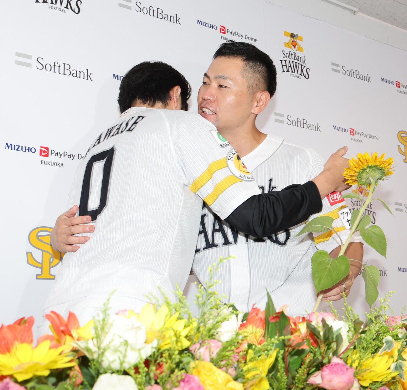 引退会見を終えたソフトバンク中村晃は川瀬晃から一輪の花を渡され笑顔（撮影・梅根麻紀）