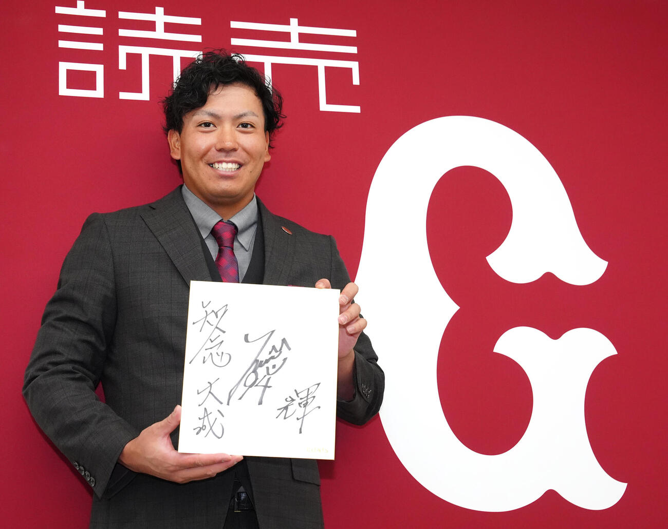支配下登録され、会見後に背番号「94」と抱負を「輝」と色紙に記した巨人知念大成（撮影・江口和貴）