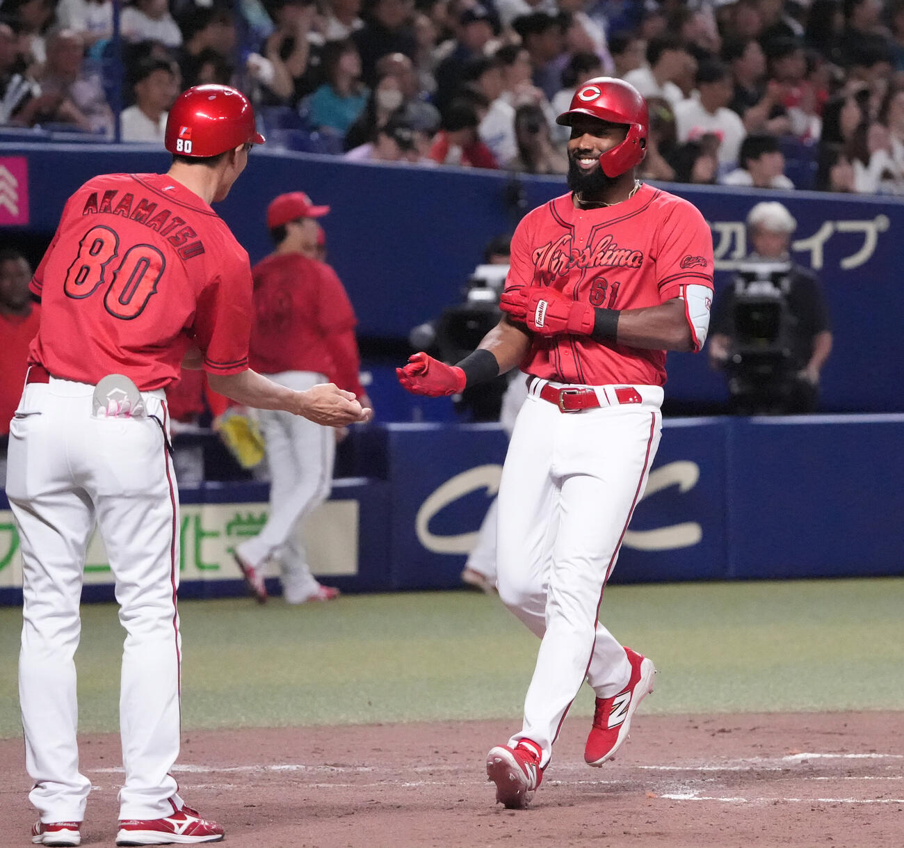 中日対広島　4回表広島2死、サンドロ・ファビアン（右）は本塁打を放ち明るい表情で生還する（撮影・森本幸一）