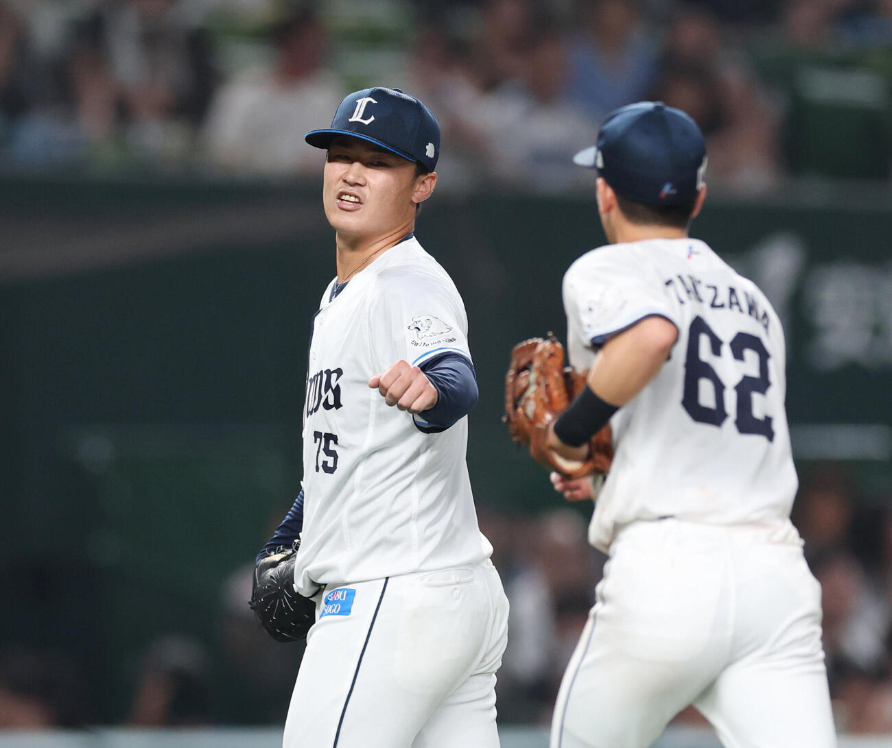 西武対ロッテ　5回表を抑え滝沢夏央（右）とタッチを交わす佐藤爽（撮影・増田悦実）