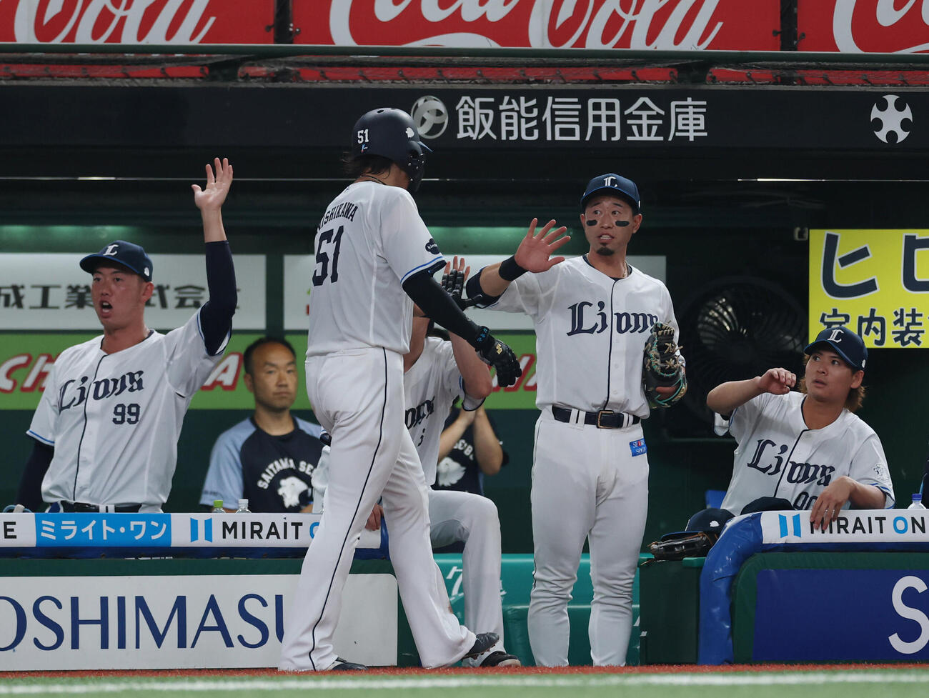 西武対ロッテ　1回裏西武1死満塁、石井一成の犠飛で生還しナインとタッチを交わす西川愛也（中央左）（撮影・増田悦実）