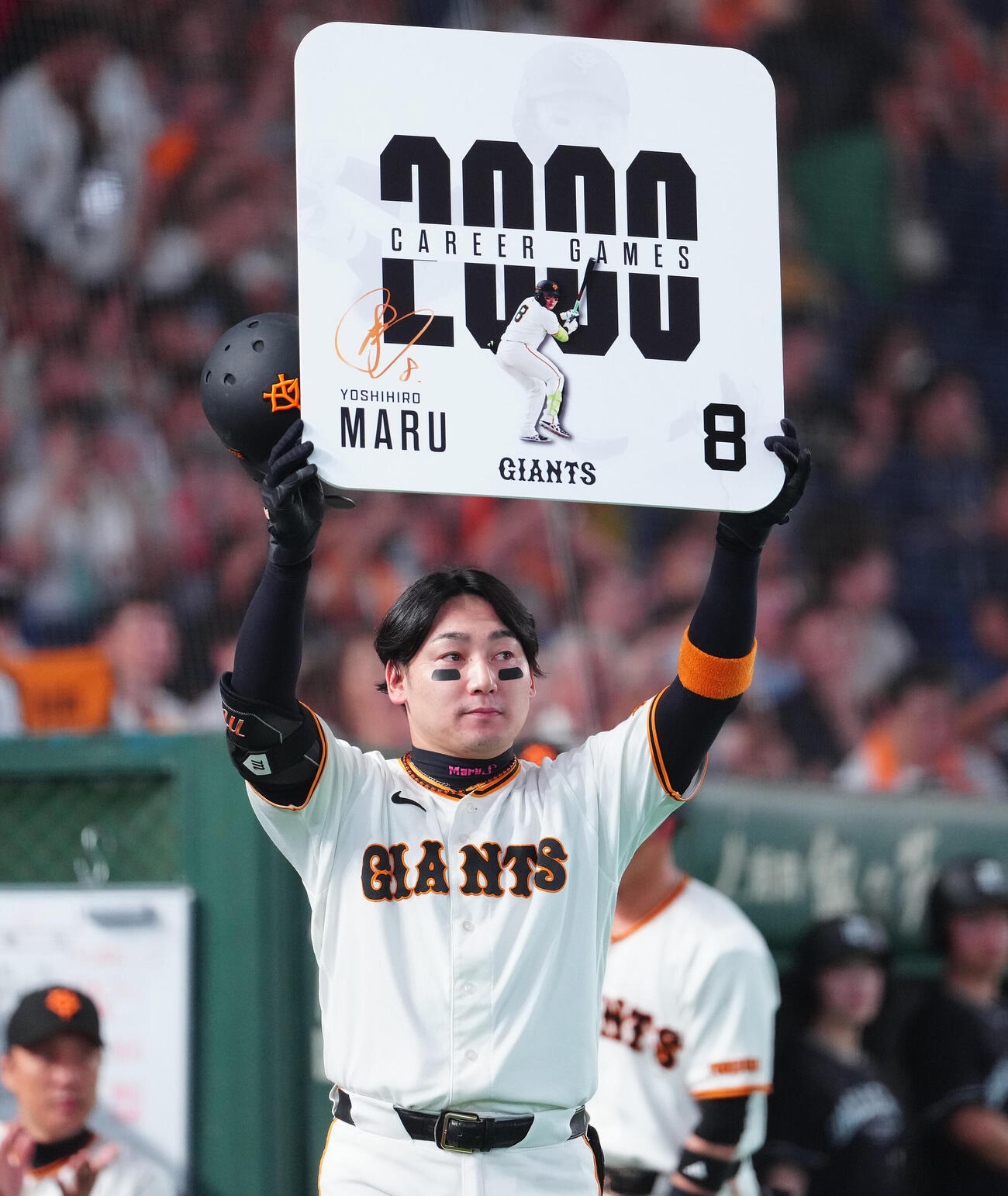 巨人対広島　通算2000試合出場を達成し、ボードを掲げる巨人丸佳浩（撮影・鈴木みどり）