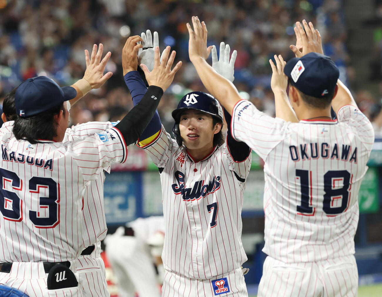 ヤクルト対中日　6回裏ヤクルト2死一、二塁、3点本塁打を放ちナインと笑顔でタッチを交わす長岡秀樹（撮影・増田悦実）