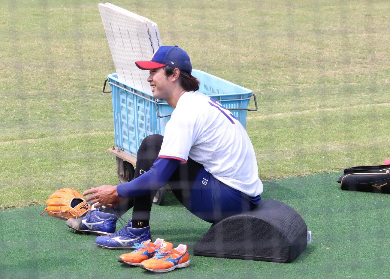 投手練習に参加し笑顔で靴ひもを結ぶ中日高橋宏斗