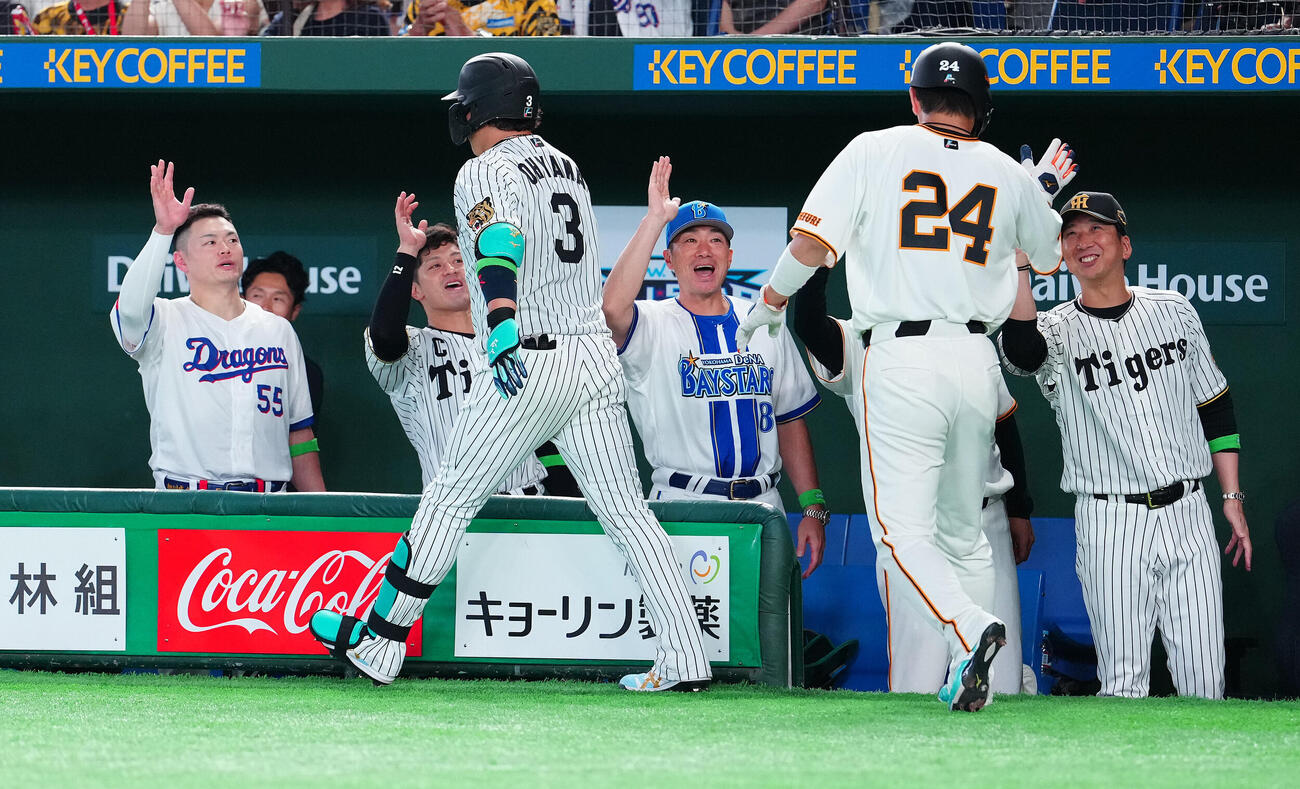 全セ対全パ　8回裏全セ1死二塁、2点本塁打を放った大山悠輔（左手前）をは笑顔で迎える藤川球児監督（右）ら（撮影・鈴木みどり）