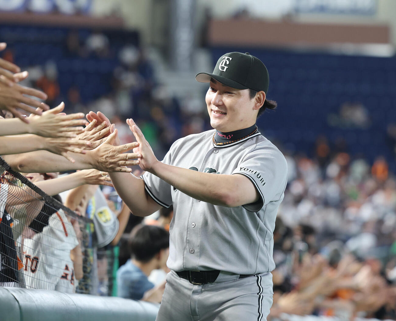 巨人対ヤクルト　勝利し観客とタッチをする巨人丸佳浩（撮影・増田悦実）