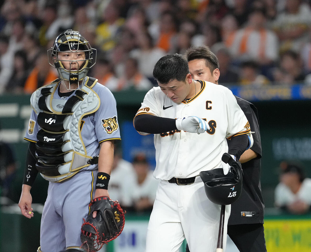 12日阪神戦の5回、自打球を顔面に当て痛がる岸田行倫