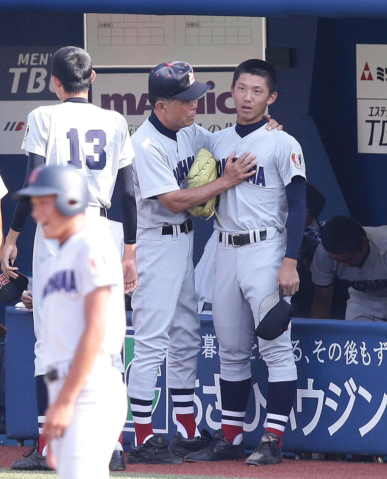 2014年7月、神奈川大会準決勝の東海大相模戦で、渡辺元智監督（中央）から胸に手を当てられ声をかけられる横浜・伊藤将司