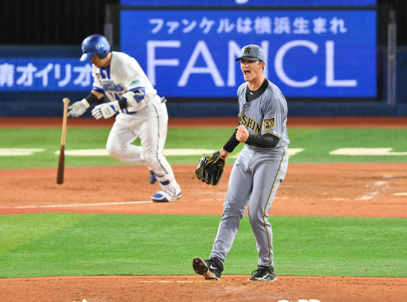 DeNA対阪神　3回裏DeNA2死一、二塁、宮崎敏郎（後方）を二ゴロに打ち取りガッツポーズするイーストン・ルーカス（撮影・滝沢徹郎）
