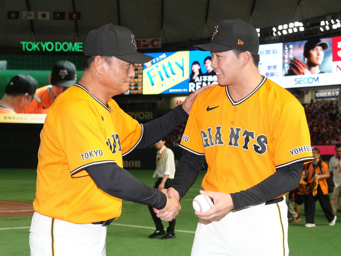 巨人対広島　プロ初勝利を挙げた巨人代木大和（右）は橋上秀樹監督代行と握手を交わす（撮影・足立雅史）
