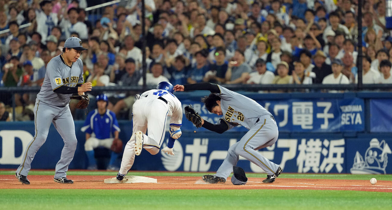 DeNA対阪神　4回裏DeNA2死満塁、勝又温史の打球をファンブルした高橋遥人は、接触し倒れ込む（撮影・たえ見朱実）