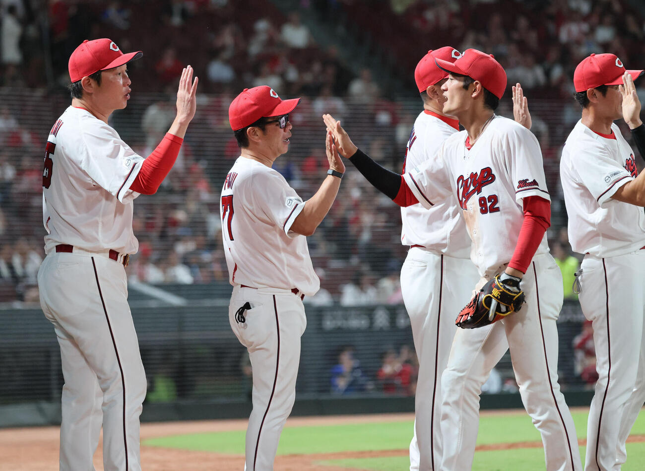 広島対DeNA DeNAに連勝した広島ナインを迎える新井貴浩監督（左）（撮影・加藤孝規）