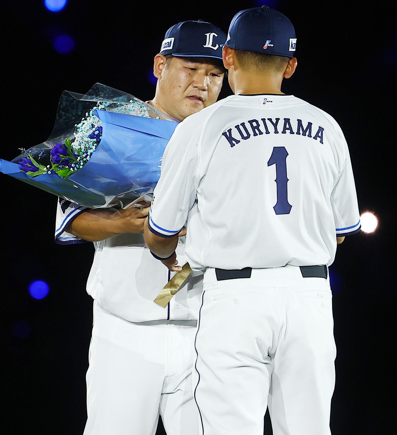 西武対楽天　栗山巧（右）の引退セレモニーで、花束を渡す中村剛也（撮影・野上伸悟）