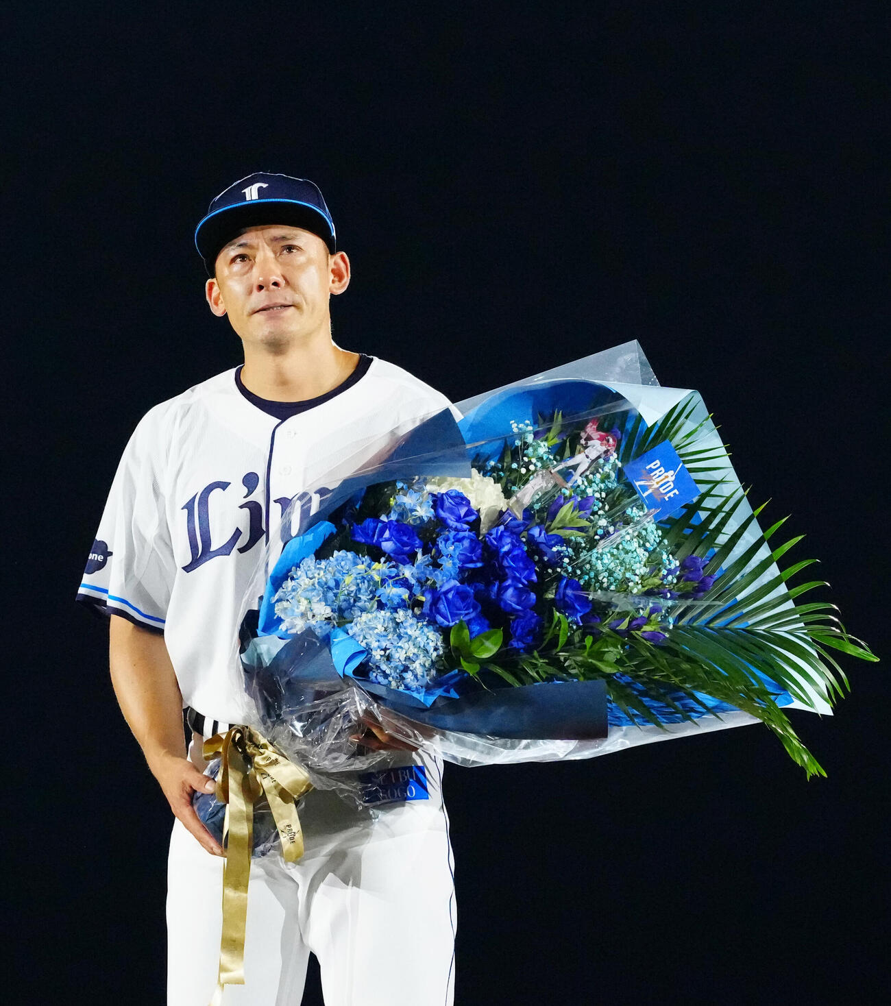 2026年8月30日、引退セレモニーで花束を手にする西武栗山巧