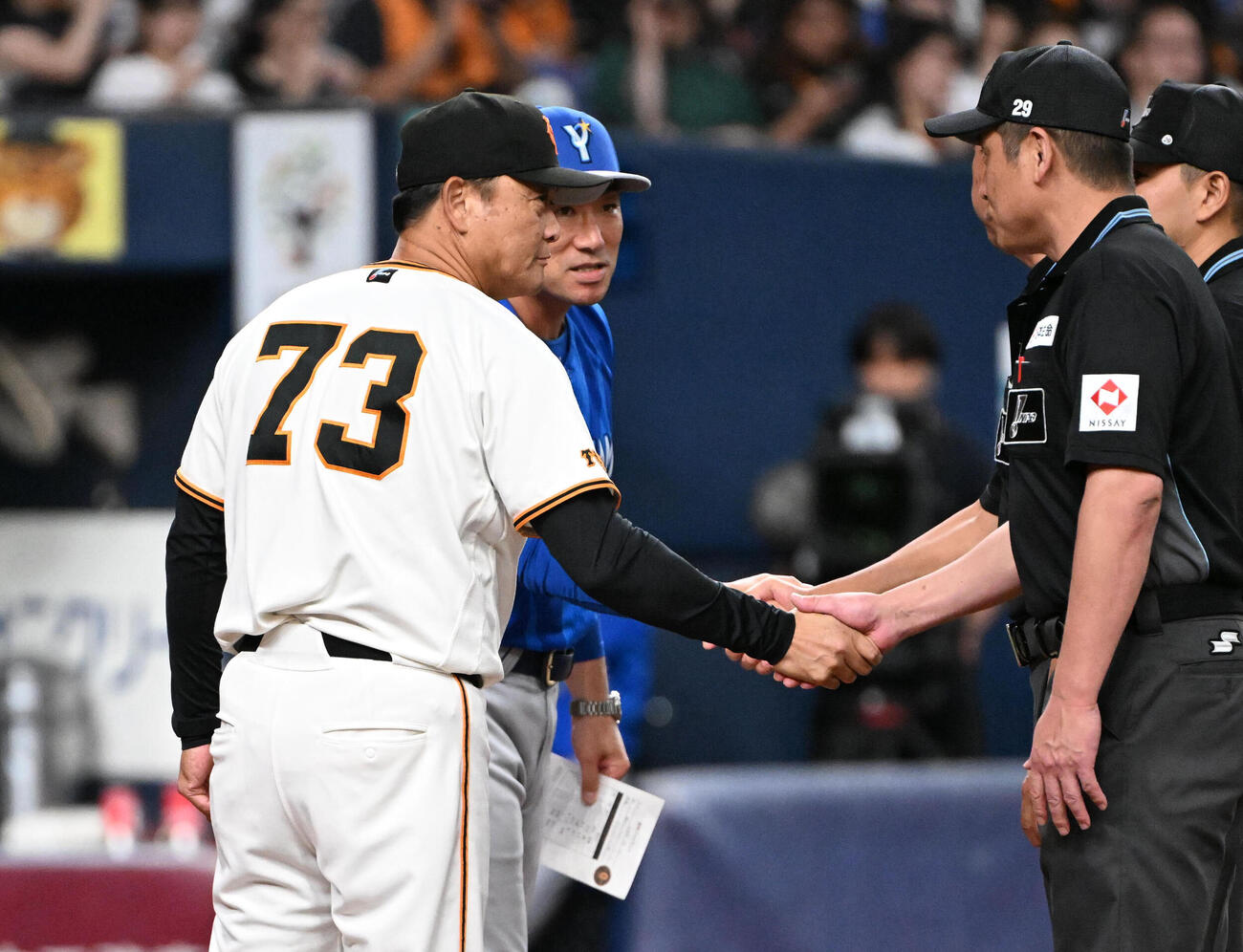 巨人対DeNA　メンバー表を交換し審判と握手をするDeNAの相川亮二監督（左から2人目）、巨人の橋上秀樹監督代行（左）（撮影・石井愛子）