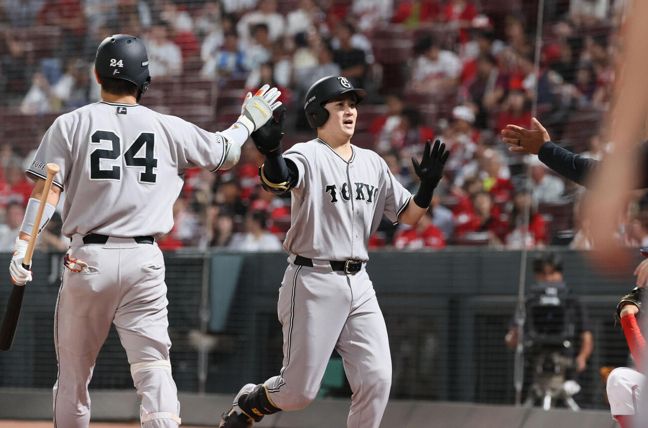 広島対巨人　3回表巨人1死一、二塁、先制右越え3点本塁打を放ちチームメートに迎えられる泉口友汰（撮影・加藤孝規）