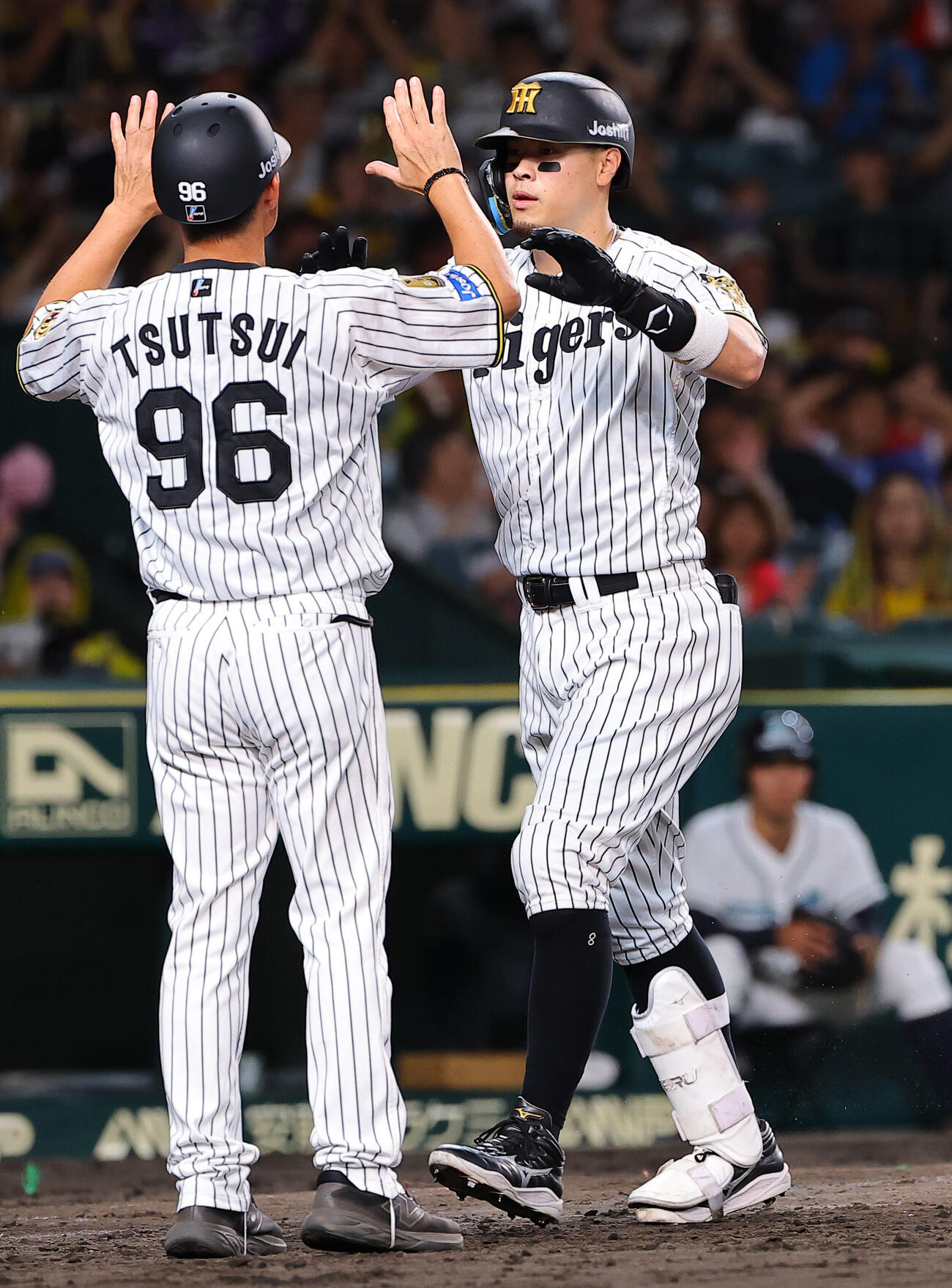 阪神対DeNA 4回裏阪神2死、本塁打を放った佐藤輝明は筒井壮コーチとハイタッチをする（撮影・上田博志）