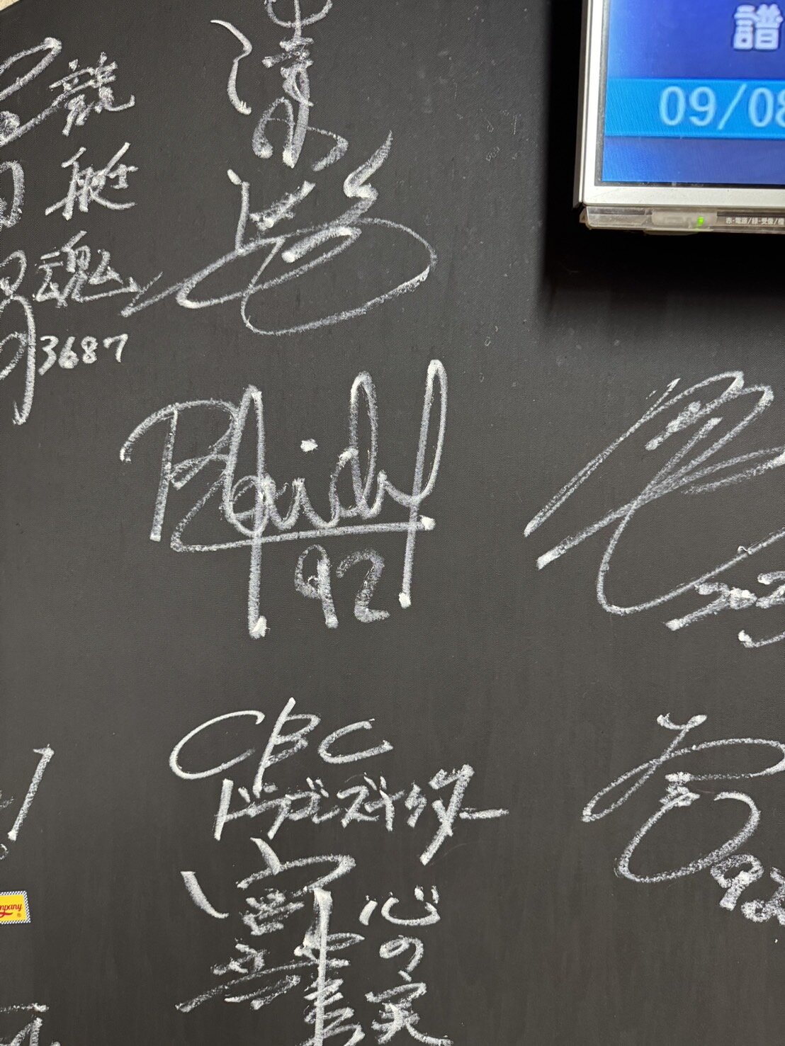 旨たつ家の店内ボードに記された中日時代のマルティネスのサイン（中央）（旨たつ家提供）