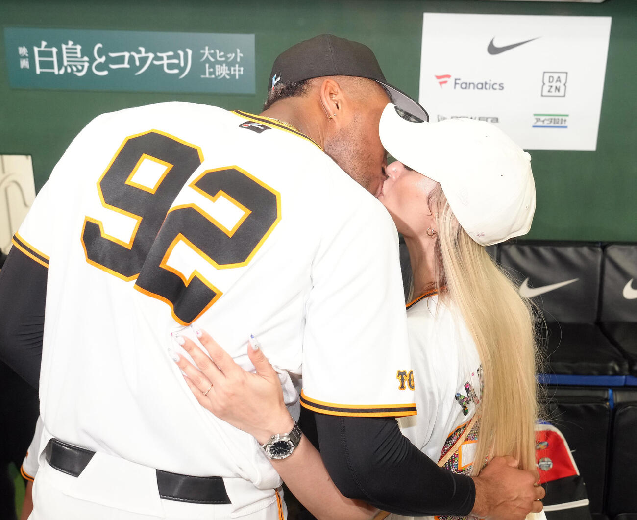 巨人対中日　通算250セーブを達成した巨人ライデル・マルティネス（左）は妻リリエンさんとキスを交わす（撮影・足立雅史）