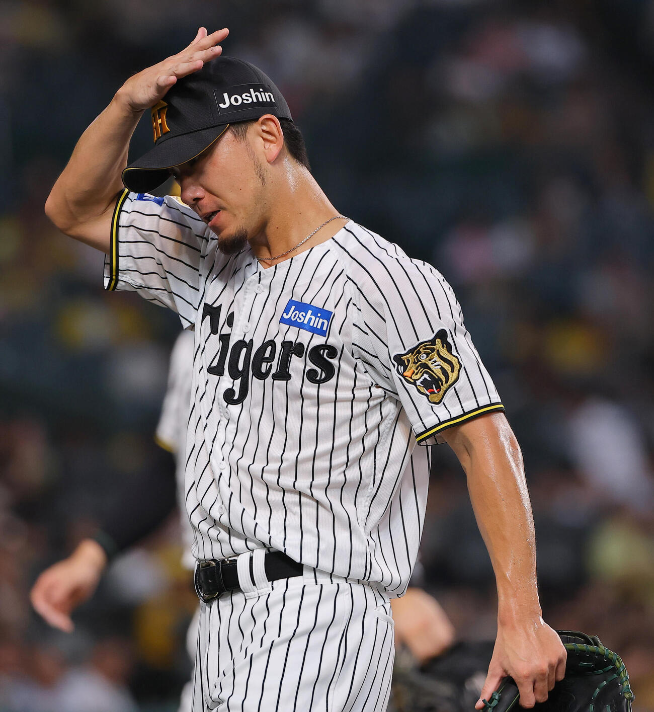 阪神対中日　1回、先制2点本塁打を浴びた伊藤将司はは頭を押さえながらベンチに引き揚げる（撮影・上田博志）