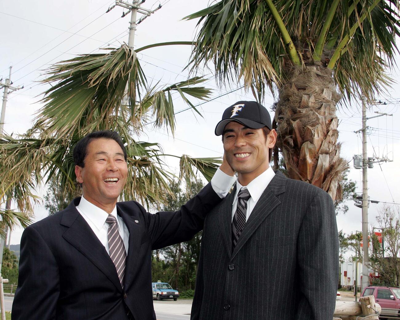05年2月、沖縄・名護での日本ハム入団発表　高田GMに帽子をかぶせてもらう稲葉篤紀