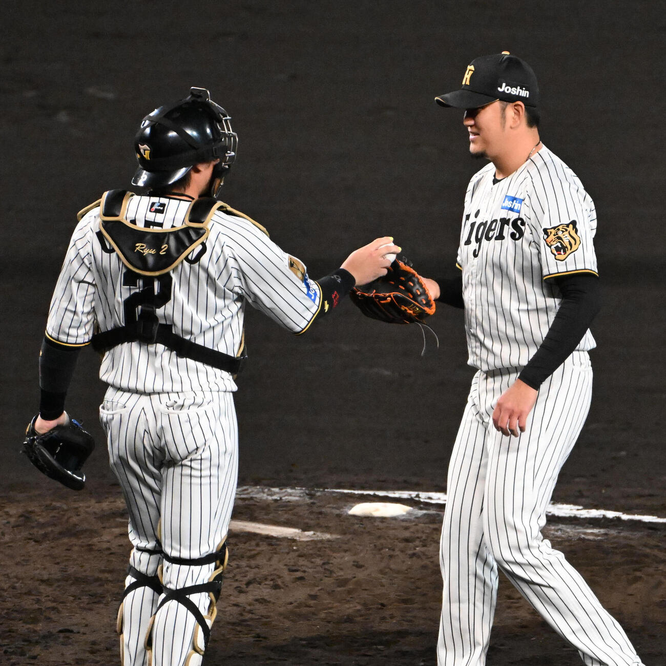 阪神対広島　7回表、投球前に梅野隆太郎（左）からボールを受け取る岩貞祐太（撮影・石井愛子）