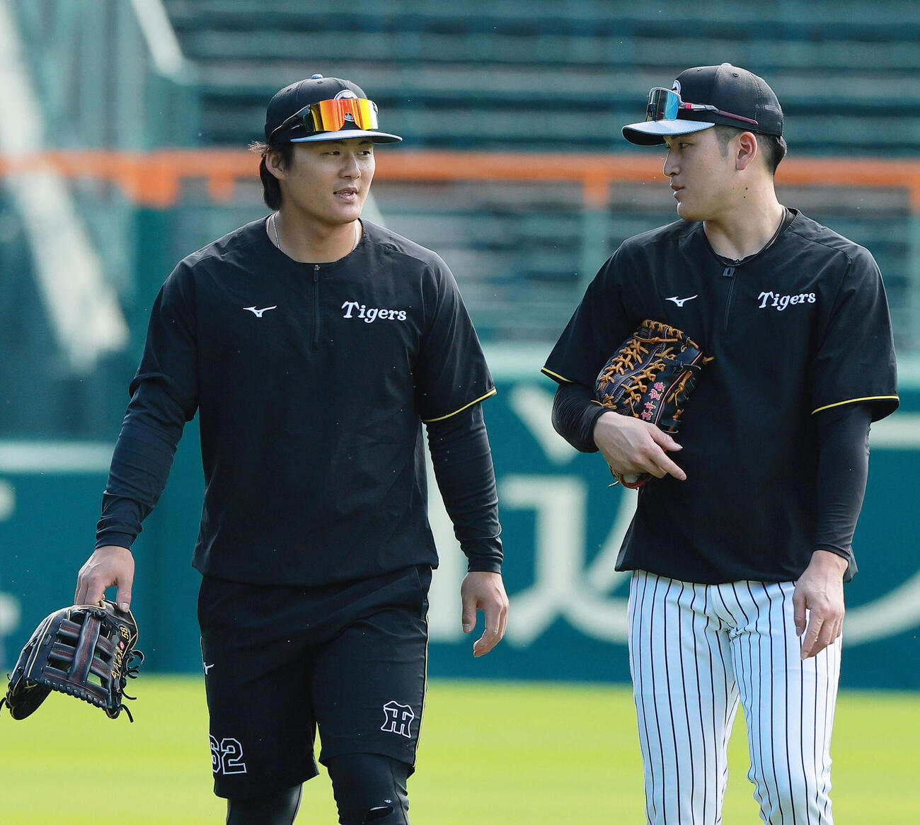 話しながらグラウンドを移動する阪神前川右京（左）と高寺望夢（撮影・上山淳一）