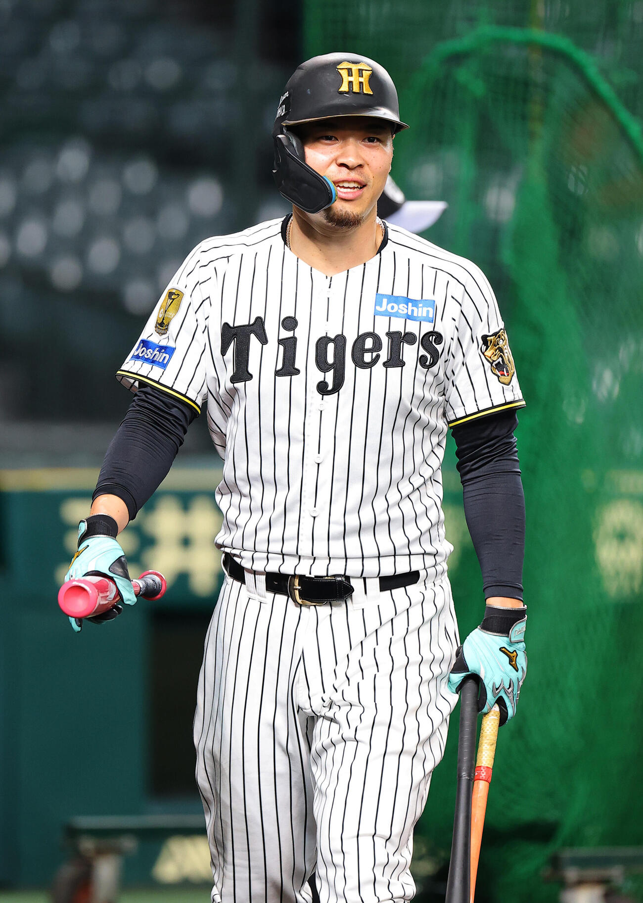 打撃練習をする佐藤輝明は笑顔を見せる（撮影・上田博志）