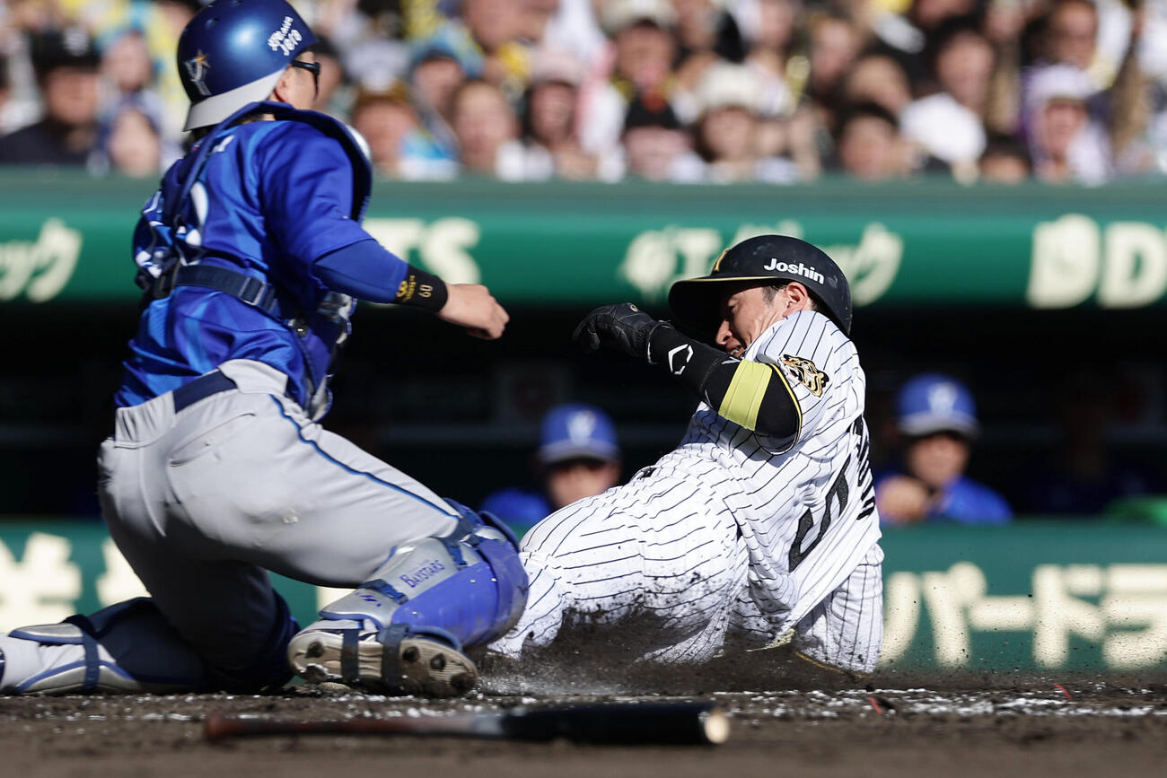 阪神対DeNA 1回裏阪神2死一、二塁、大山悠輔の適時打で生還する近本光司。捕手古市尊（撮影・前田充）
