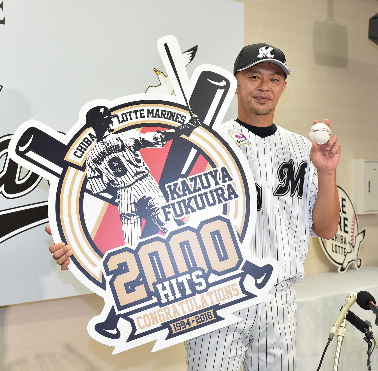 通算2000安打を放ったロッテ福浦は記念球とボードを手に笑顔（2018年9月）