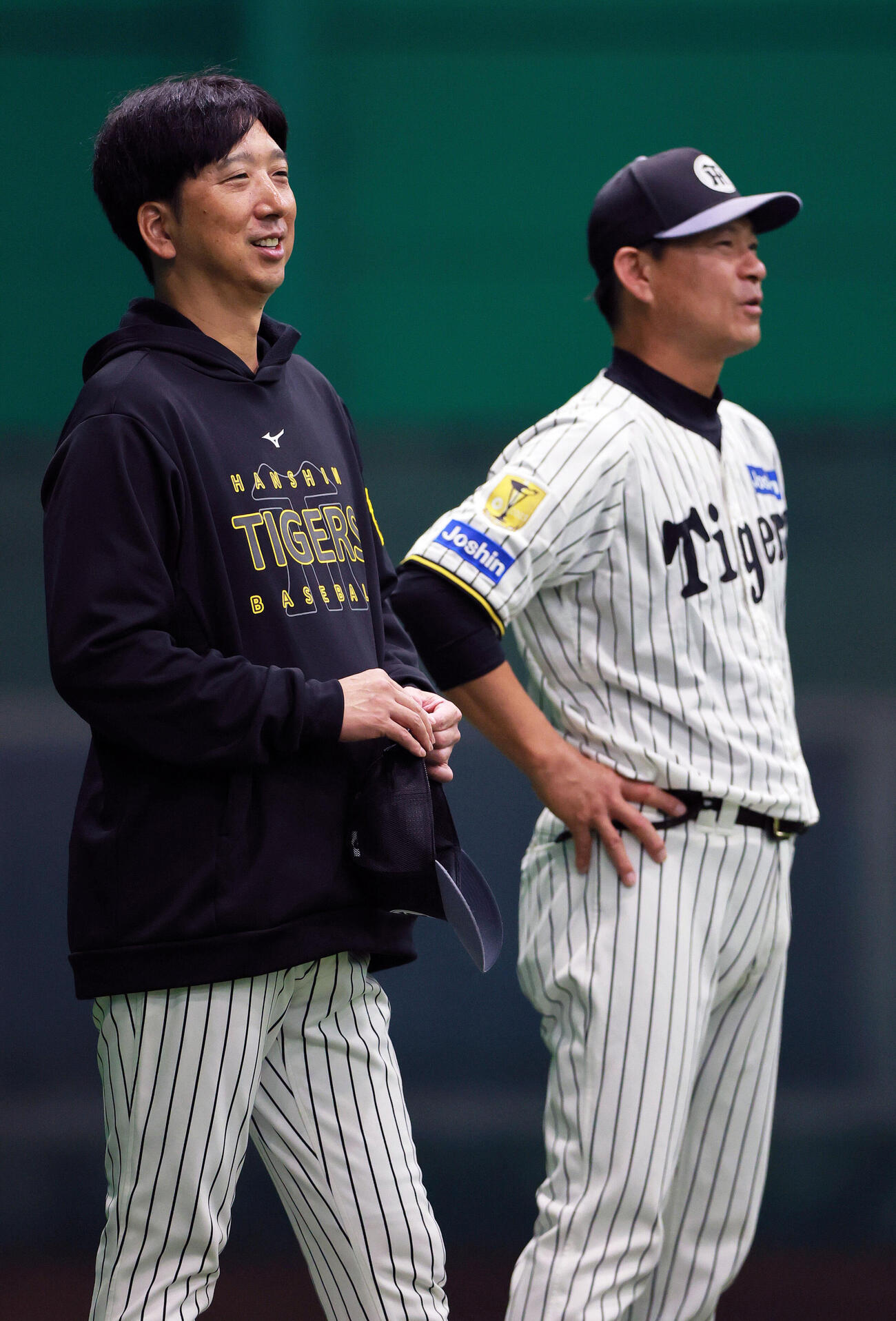 リラックスした表情で阪神筒井壮外野守備兼走塁チーフコーチ（右）と話す藤川球児監督（撮影・上山淳一）