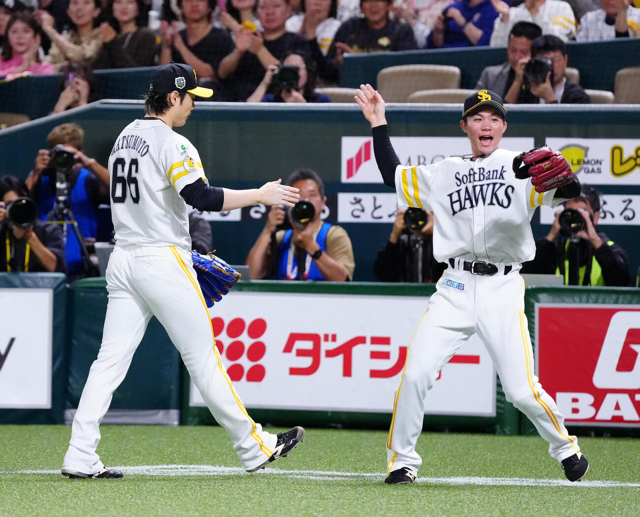 ソフトバンク対DeNA 8回表終了後、ソフトバンク遊撃手庄子雄大（右）とタッチを交わす5番手の松本裕樹（撮影・江口和貴）