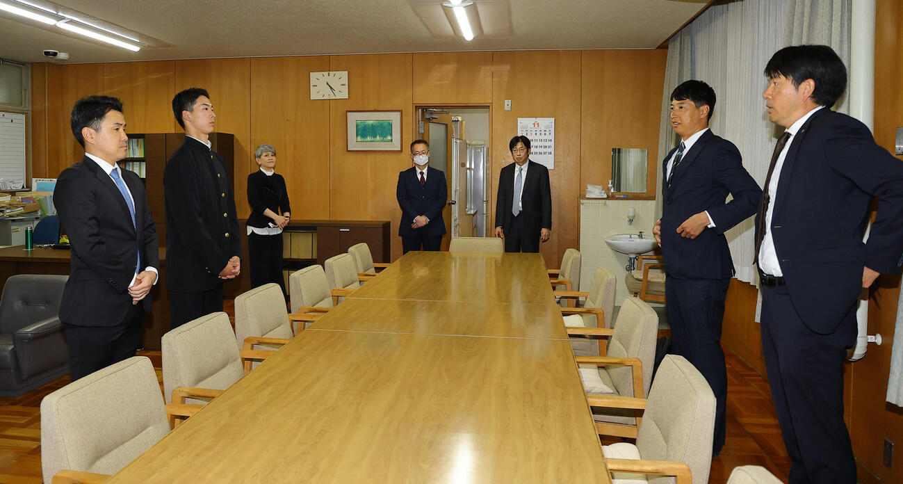 日本ハムドラフト5位指名の大阪府立香里丘高校・岡本翔斗（左から2人目）と河本拓也監督（左）は加藤竜人スカウト（右）と村田透スカウトの指名あいさつを受ける（撮影・上田博志）